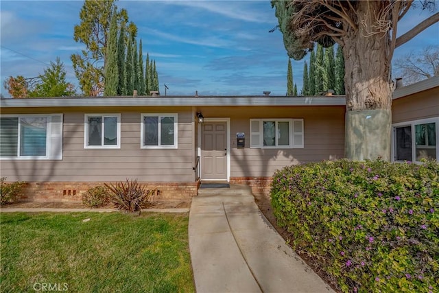 ranch-style house with a front lawn