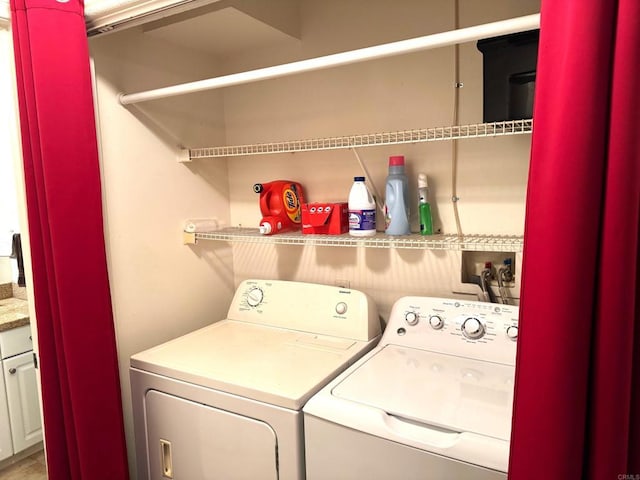 washroom featuring laundry area and separate washer and dryer