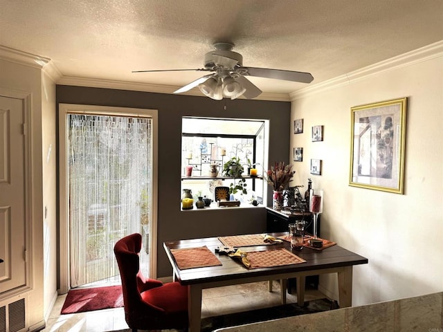 dining space featuring crown molding, a textured ceiling, visible vents, and a healthy amount of sunlight