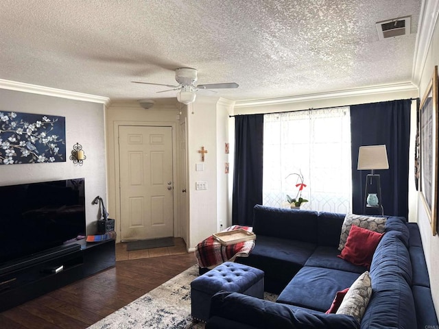 living area featuring a textured ceiling, ceiling fan, wood finished floors, visible vents, and ornamental molding