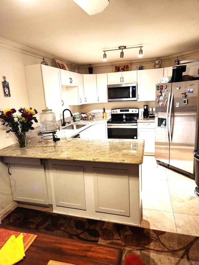 kitchen with appliances with stainless steel finishes, white cabinets, and light stone countertops