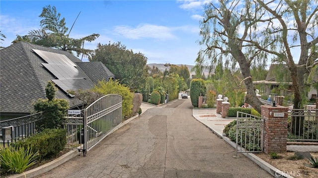 view of street featuring a gate and a gated entry