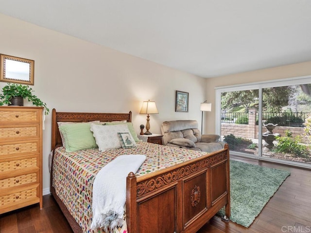 bedroom featuring access to exterior and dark hardwood / wood-style floors