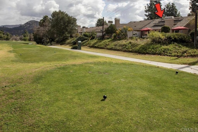 view of property's community featuring a mountain view and a lawn