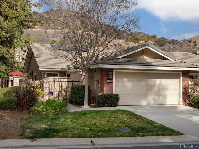 view of front of home with a garage and a mountain view