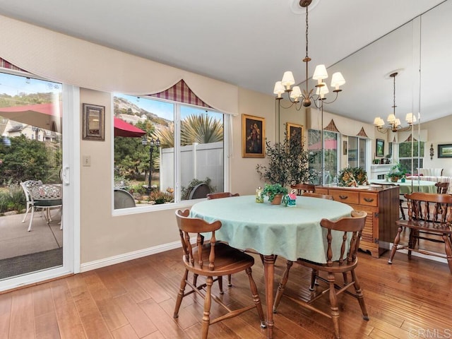 dining room with hardwood / wood-style flooring and a notable chandelier