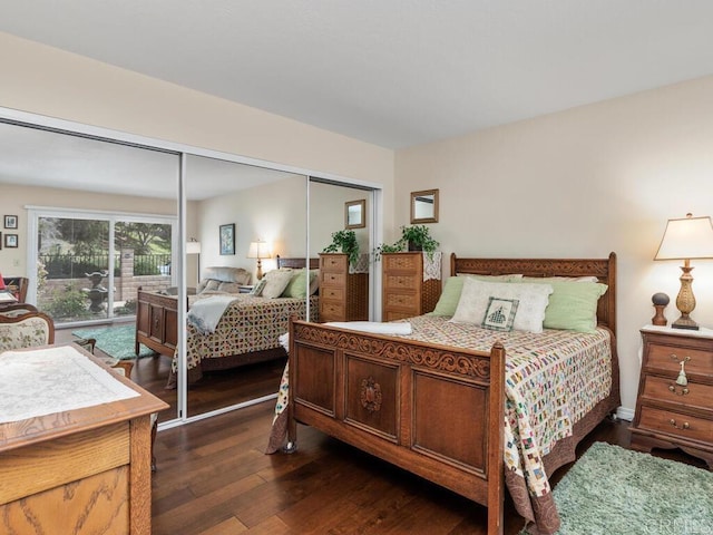 bedroom with dark wood-type flooring and a closet