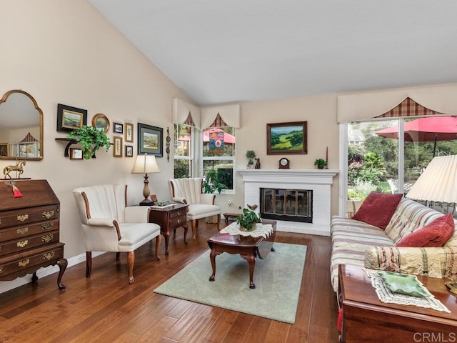 living room featuring dark hardwood / wood-style flooring, a fireplace, and vaulted ceiling