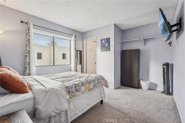 bedroom featuring light colored carpet and a textured ceiling