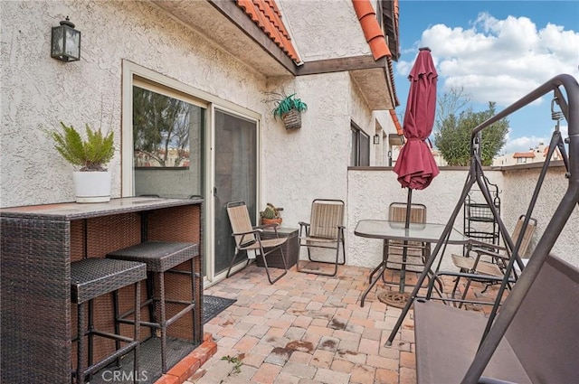 view of patio / terrace featuring an outdoor bar