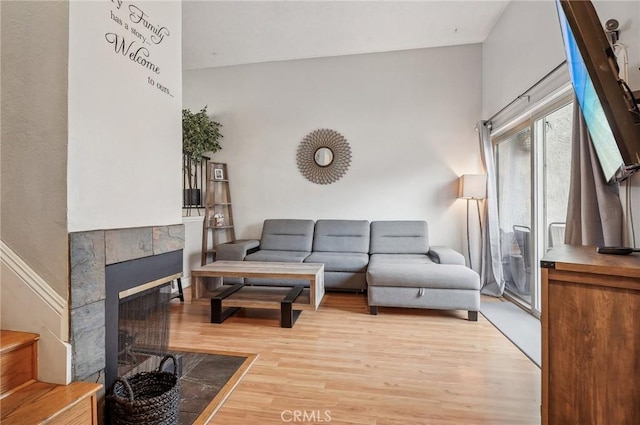 living room featuring light hardwood / wood-style flooring and a fireplace