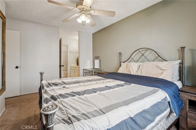 carpeted bedroom with ceiling fan, connected bathroom, and a textured ceiling