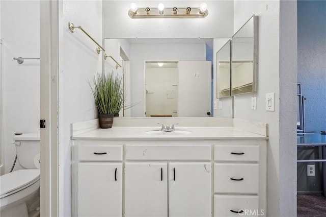 bathroom featuring vanity and toilet