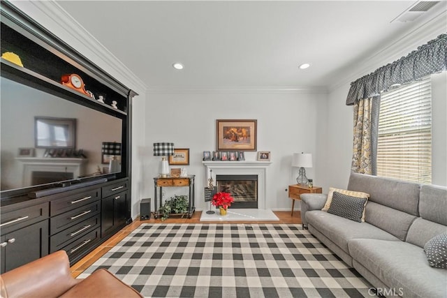 living room featuring ornamental molding and light hardwood / wood-style flooring