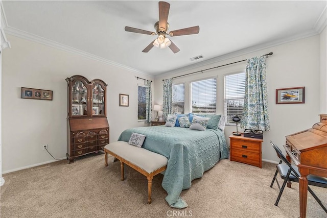 carpeted bedroom featuring crown molding and ceiling fan