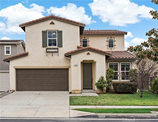 mediterranean / spanish home with a garage and a front lawn