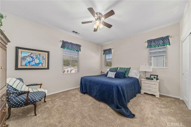 carpeted bedroom featuring multiple windows, a closet, and ceiling fan