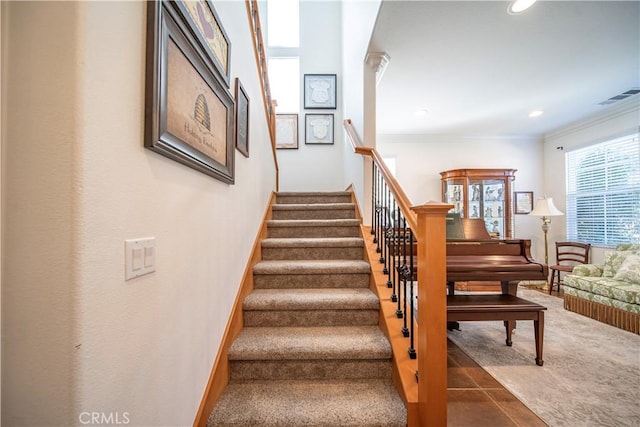 stairway featuring ornamental molding and carpet flooring