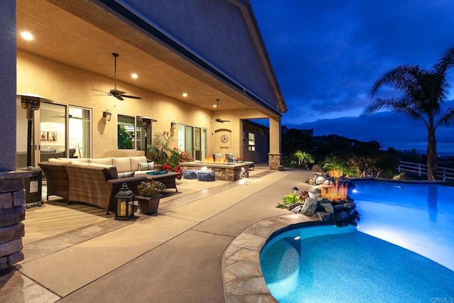 view of swimming pool with a patio area, an outdoor living space with a fire pit, and ceiling fan