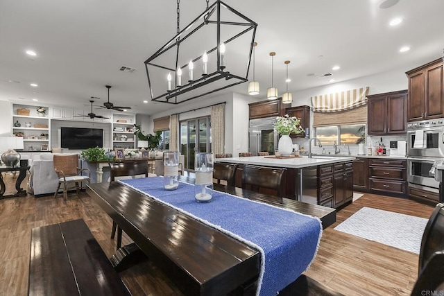 dining area with dark hardwood / wood-style flooring and ceiling fan