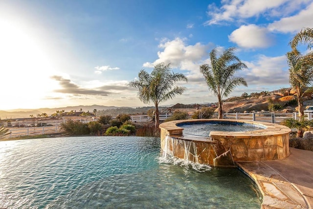 pool at dusk with pool water feature