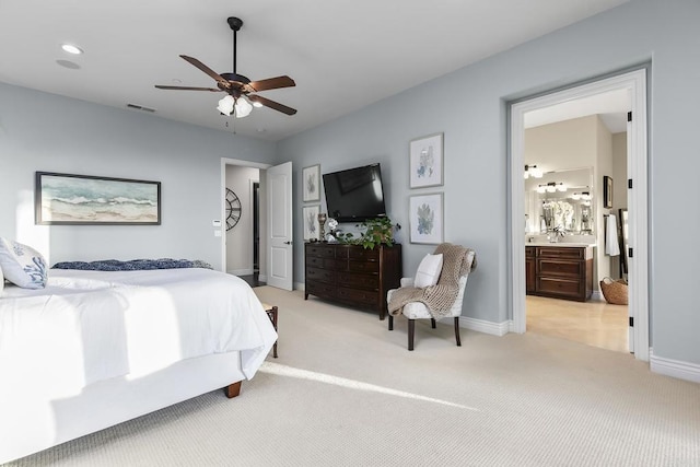 carpeted bedroom featuring ceiling fan and ensuite bathroom