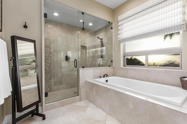 bathroom with separate shower and tub