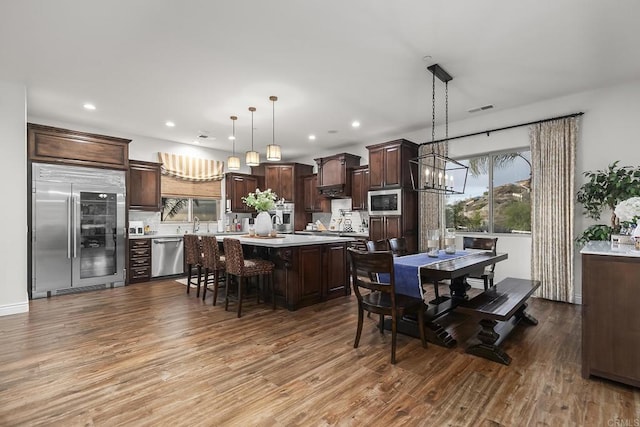 dining area with an inviting chandelier and light hardwood / wood-style flooring