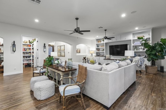 living room with ceiling fan, dark hardwood / wood-style floors, and built in features