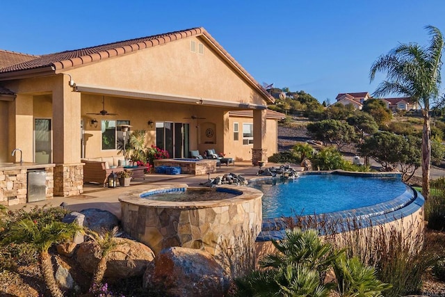 view of pool featuring a patio, ceiling fan, and an in ground hot tub