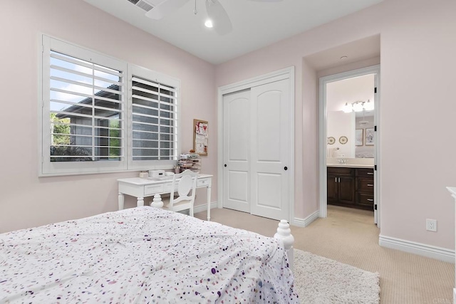 carpeted bedroom with sink, a closet, and ceiling fan