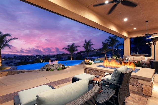 patio terrace at dusk featuring an outdoor living space with a fire pit