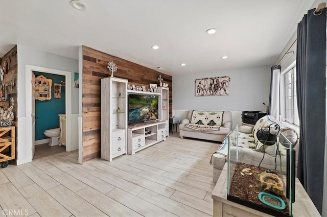 living room featuring wooden walls and light wood-type flooring