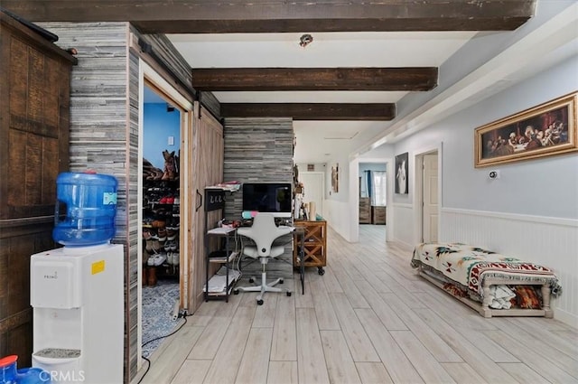 home office featuring beam ceiling and light hardwood / wood-style floors