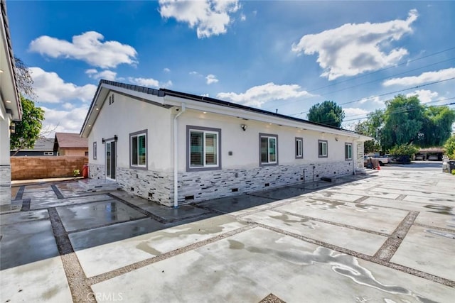 7631 Columbia St, Rosemead, CA 91770 - view of property exterior featuring stucco siding, stone siding, fence, and a patio