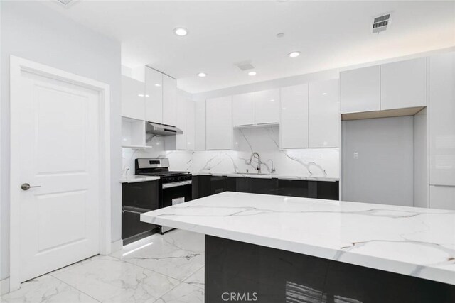 7631 Columbia St, Rosemead, CA 91770 - kitchen featuring white cabinets, modern cabinets, a sink, under cabinet range hood, and stainless steel range with gas stovetop