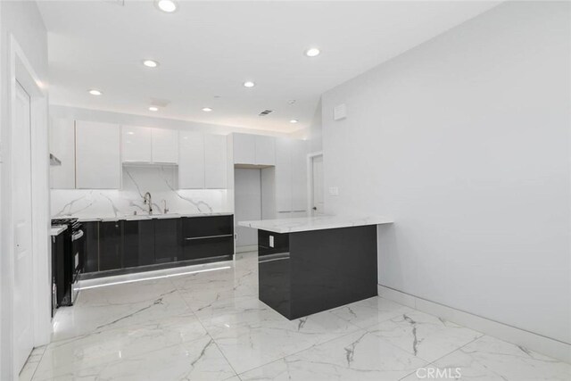 7631 Columbia St, Rosemead, CA 91770 - kitchen with modern cabinets, white cabinets, recessed lighting, light marble finish floors, and light stone countertops