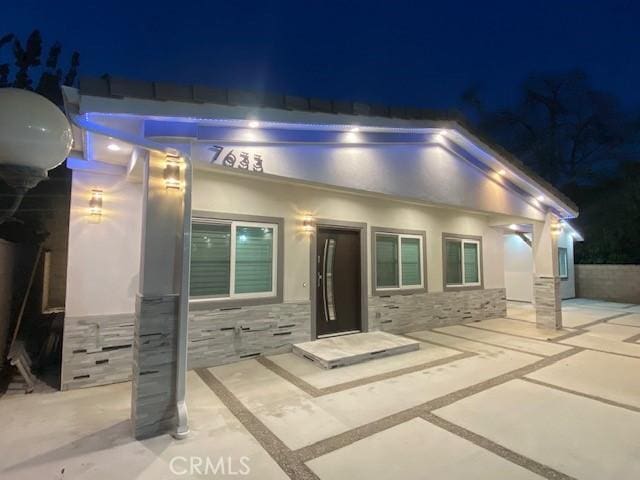 7631 Columbia St, Rosemead, CA 91770 - view of front of home featuring stone siding, a patio, and stucco siding