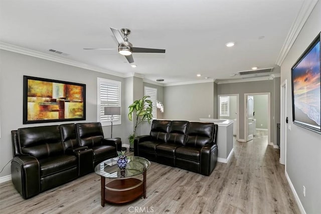 living room featuring ornamental molding, ceiling fan, and light wood-type flooring