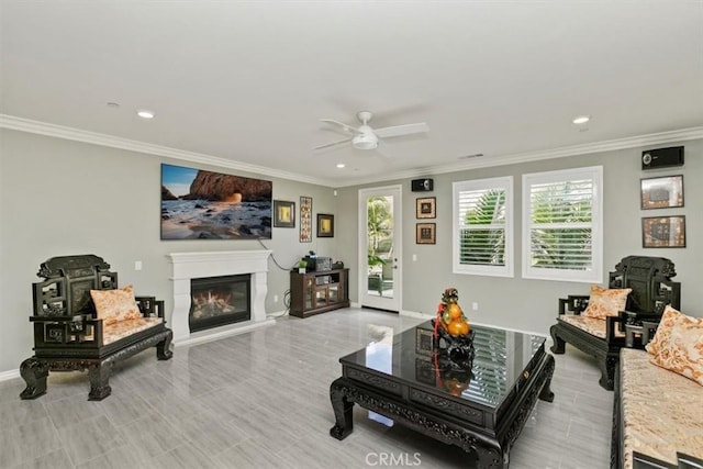 living room featuring ornamental molding and ceiling fan