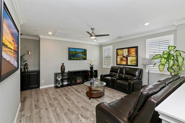 living room featuring ornamental molding, ceiling fan, and light wood-type flooring