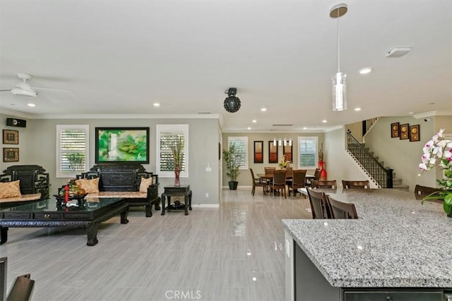 living room featuring crown molding and ceiling fan