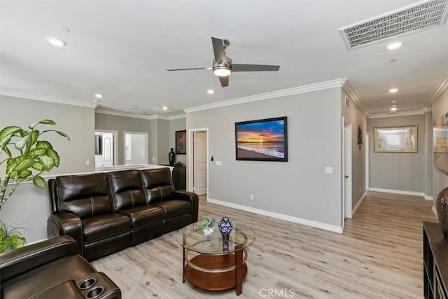 living room featuring ceiling fan, ornamental molding, and light wood-type flooring