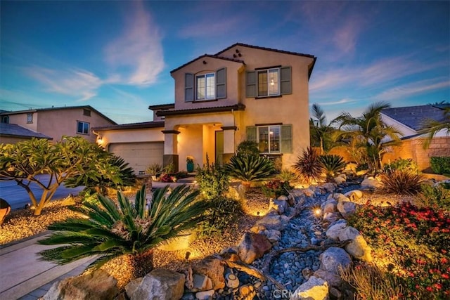 mediterranean / spanish-style home featuring a garage