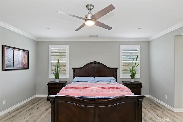 bedroom featuring ornamental molding, ceiling fan, and light wood-type flooring