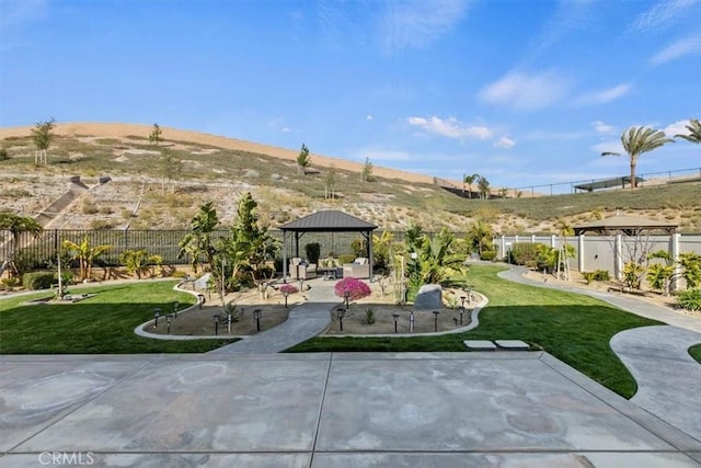 view of yard featuring a gazebo and a mountain view