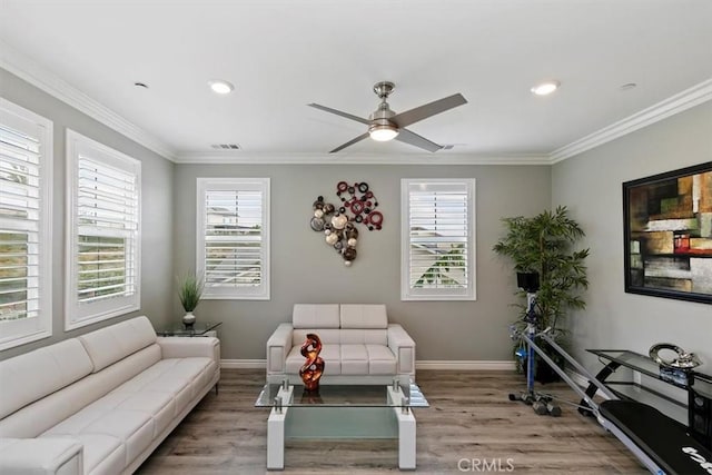 living room with ceiling fan, ornamental molding, and light hardwood / wood-style flooring