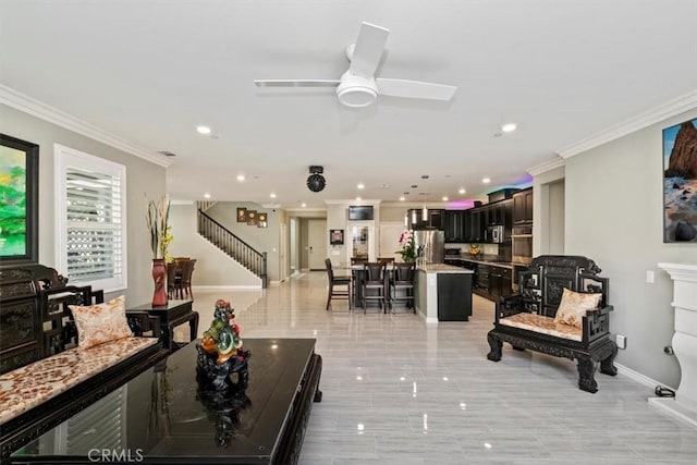 living room with crown molding and ceiling fan