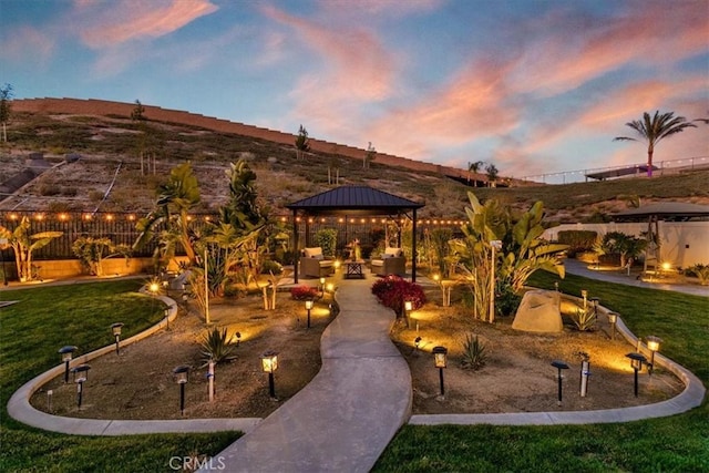 view of property's community with a gazebo, a mountain view, and a yard