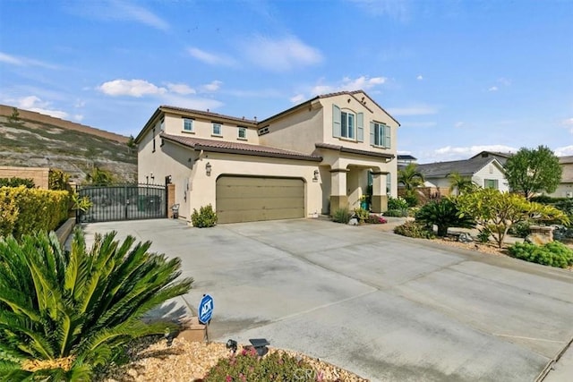 mediterranean / spanish-style home with a garage